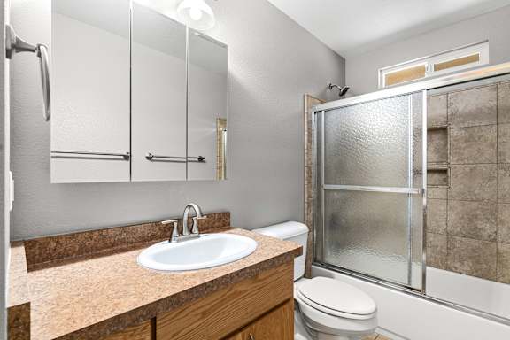 Bathroom with a sink, toilet, and shower at OSM Properties Homes & Apartments, California