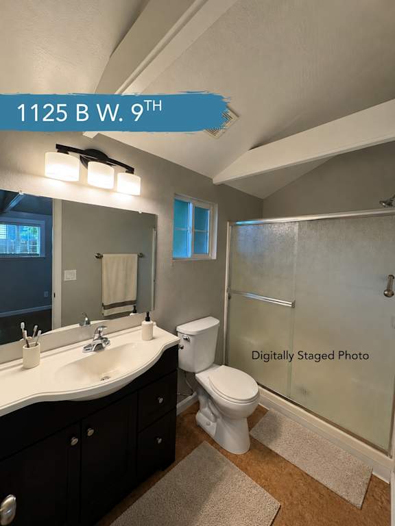 A bathroom with a sink, toilet, and shower.