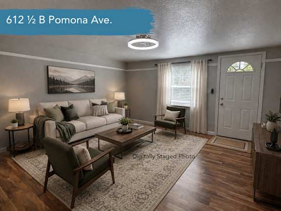 A living room with a sofa, armchair, and coffee table.