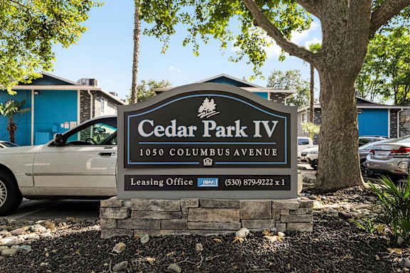 Property entrance sign with landscaping at Cedar Park Apartments, California, 95926
