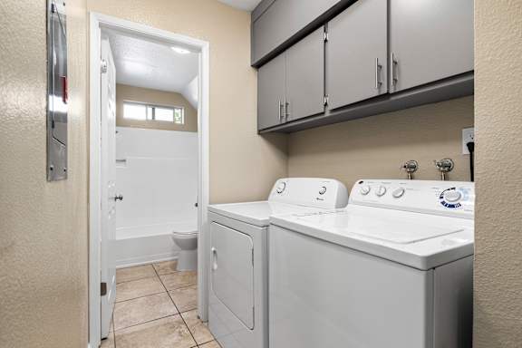 Laundry room with side by side washer and dryer at Cedar Park Apartments, Chico, CA 95926