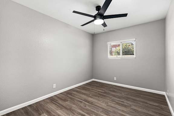Vacant bedroom with gray walls and wood laminate flooring at OSM Properties Homes & Apartments, California, 95926