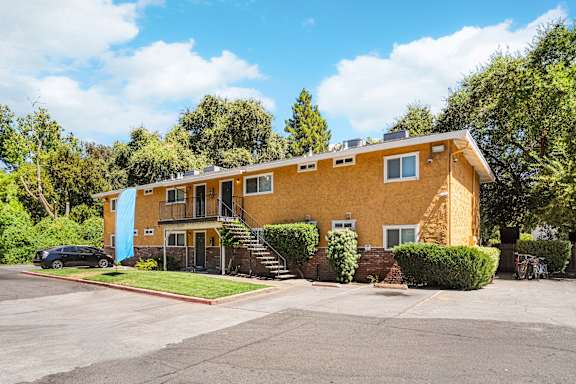 Two story apartment building with orange stucco exterior at OSM Properties Homes & Apartments, Chico, CA 95926