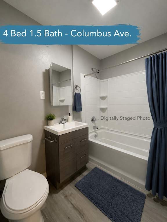 A bathroom with a toilet, sink, and bathtub.