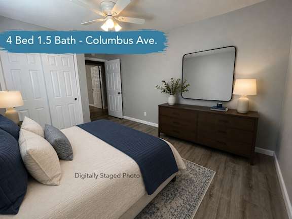 A bedroom with a bed, dresser, and mirror.