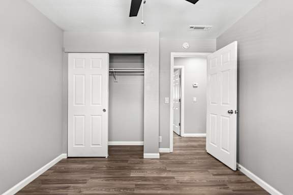 Empty bedroom with closet and hallway access at OSM Properties Homes & Apartments, Chico, CA