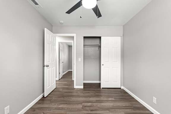 Empty bedroom with open closet and gray walls at OSM Properties Homes & Apartments, Chico, California