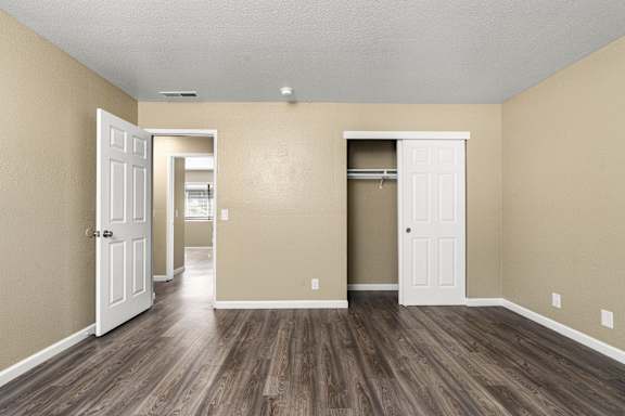 Bedroom with open closet and wood style flooring at Cedar Park Apartments, California, 95926