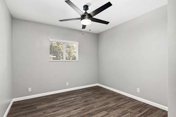 Empty bedroom with ceiling fan and window blinds at OSM Properties Homes & Apartments, Chico