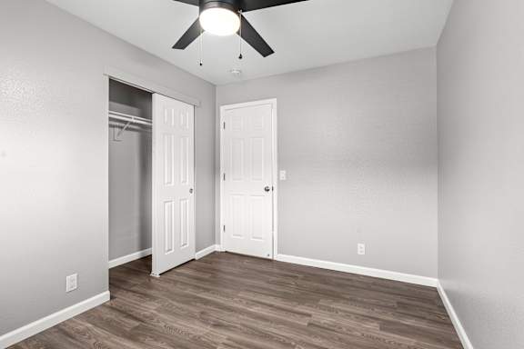 Empty bedroom with open closet and white doors at OSM Properties Homes & Apartments, California, 95926