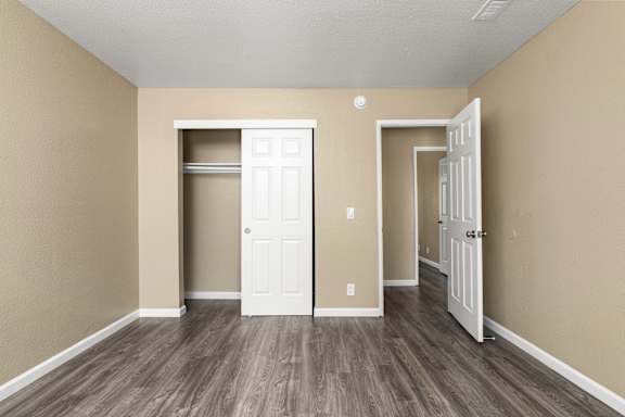 Bedroom with closet and open door to hallway at Cedar Park Apartments, Chico, CA