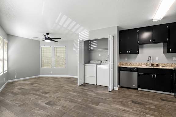 Open concept living area with laundry closet and kitchen at OSM Properties Homes & Apartments, Chico, 95926