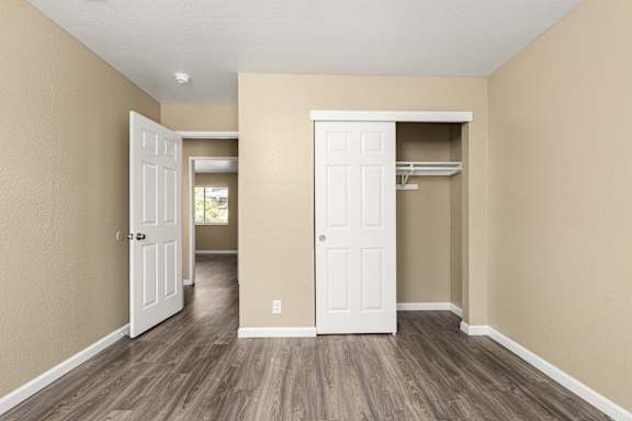 Empty bedroom with closet and wood flooring at Cedar Park Apartments, Chico