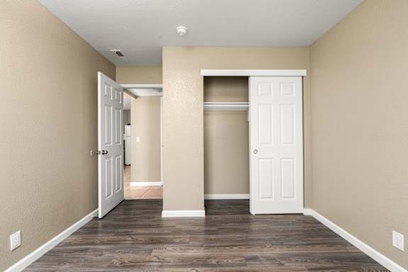 Empty bedroom with sliding closet door at Cedar Park Apartments, California, 95926
