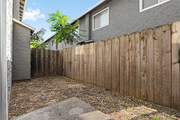 Private fenced backyard patio area at Cedar Park Apartments, Chico, California
