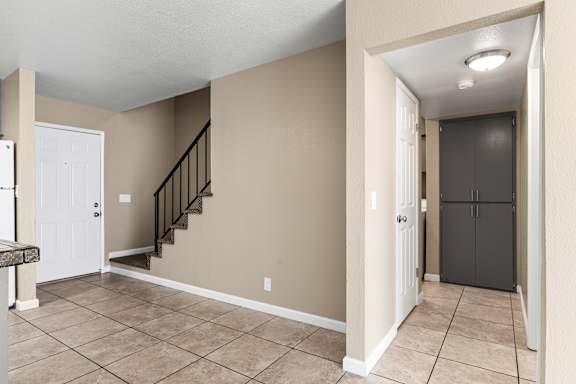 Entryway with staircase and tile flooring at Cedar Park Apartments, Chico