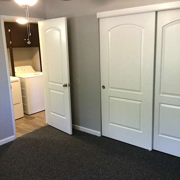 Bedroom with white closet doors and gray walls at OSM Properties Homes & Apartments, Chico, CA