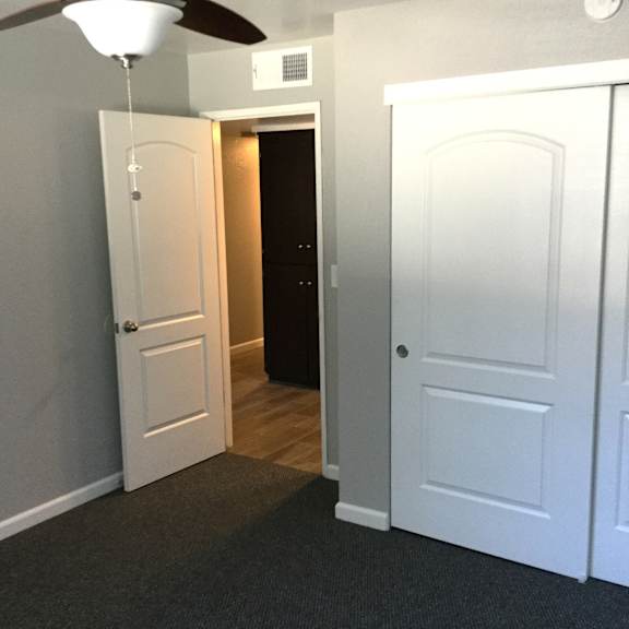 Bedroom with closet and hallway leading to entrance at OSM Properties Homes & Apartments, Chico, 95926
