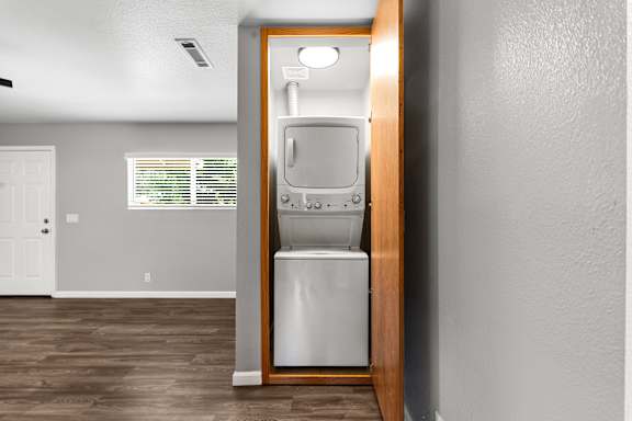 Stacked washer and dryer in closet nook at OSM Properties Homes & Apartments, Chico, California