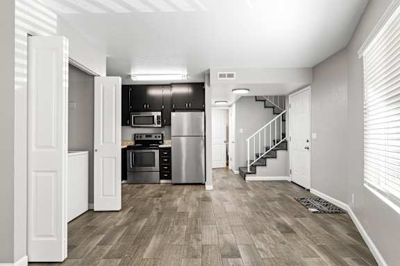 Open living space with kitchen and staircase at OSM Properties Homes & Apartments, Chico
