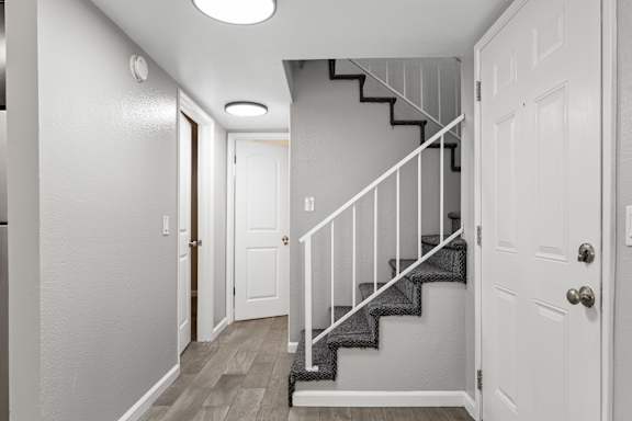 Entryway with staircase and white railing at OSM Properties Homes & Apartments, California, 95926
