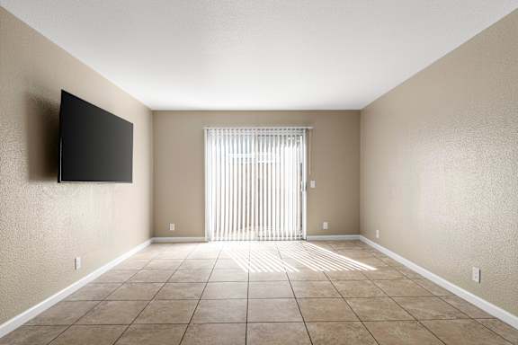 Unfurnished living room with sliding glass door at Cedar Park Apartments, Chico, 95926