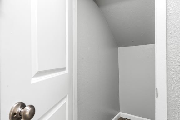 Open storage closet with white interior and door at OSM Properties Homes & Apartments, Chico, CA