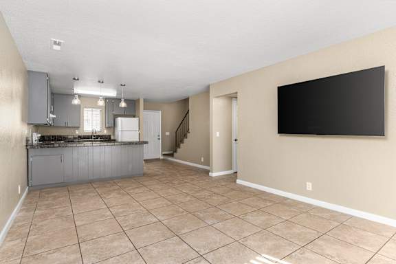 Open concept kitchen and living area with tile floor at Cedar Park Apartments, Chico, California