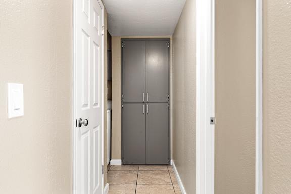 Hallway storage closet with gray cabinet doors at Cedar Park Apartments, Chico
