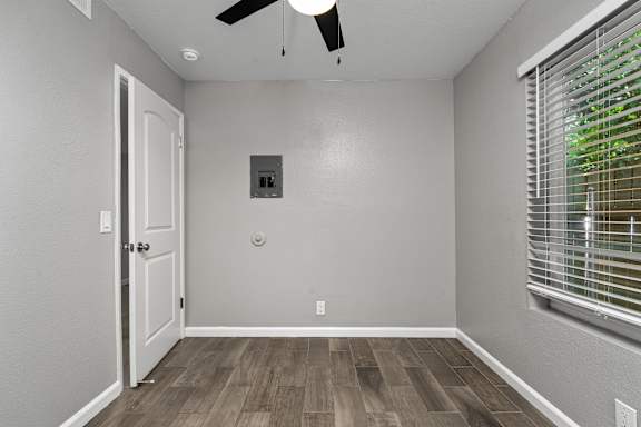 Empty room with electrical panel and window blinds at OSM Properties Homes & Apartments, California
