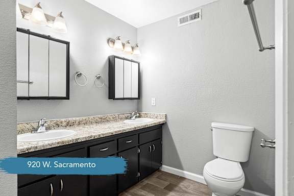 Double vanity bathroom with granite countertop and toilet at OSM Properties Homes & Apartments, Chico, 95926