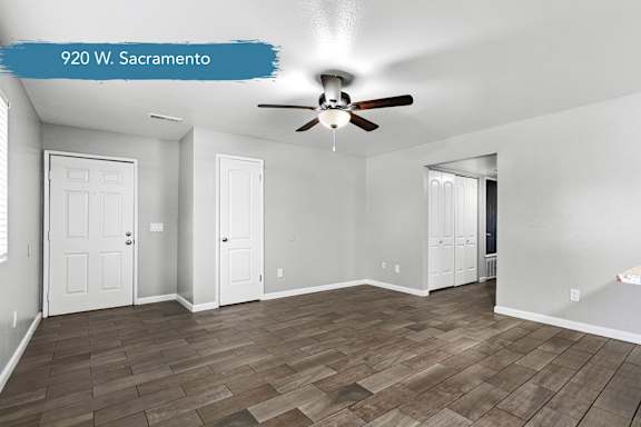 Spacious living area with ceiling fan and wood flooring at OSM Properties Homes & Apartments, Chico, CA 95926