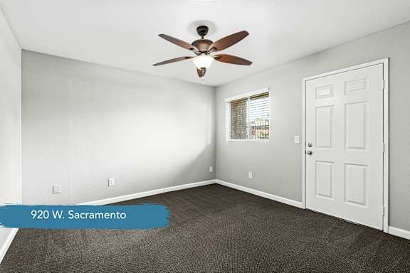 Empty room with ceiling fan and window at OSM Properties Homes & Apartments, Chico, CA