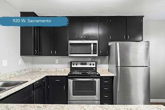 Modern kitchen with black cabinets and stainless steel range at OSM Properties Homes & Apartments, California, 95926