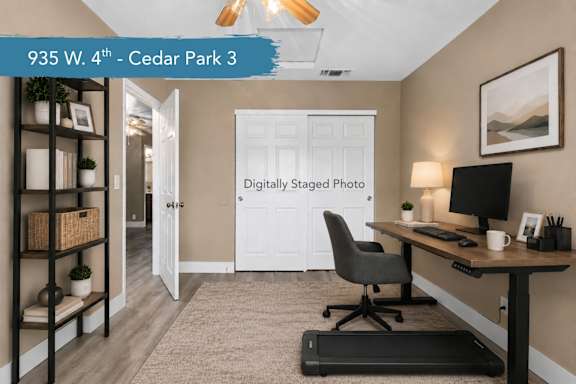 A room with a desk, chair, and shelves.