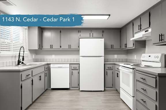 A kitchen with white appliances and cabinets.