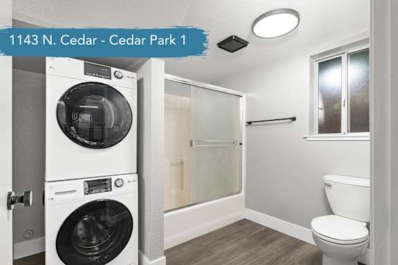 A small bathroom with a washer and dryer in it.