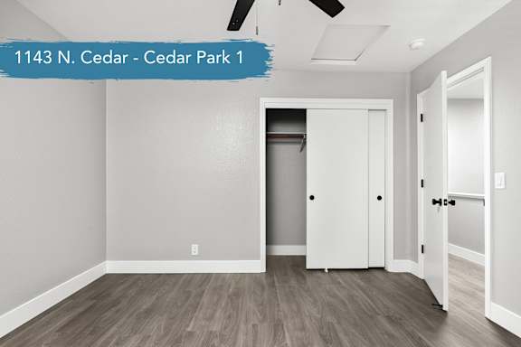 A room with a white door and a white cabinet in the middle of the room.