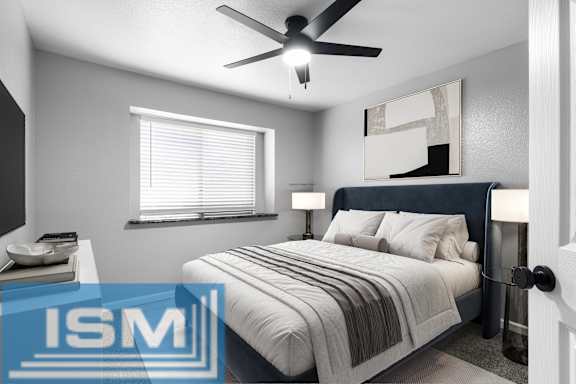 Furnished bedroom with ceiling fan and artwork at Redwood Cove Apartments, California