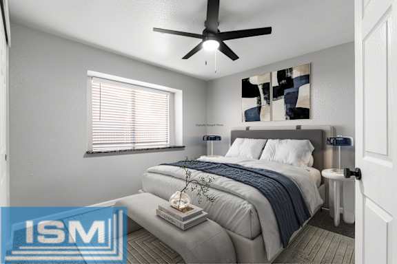 Furnished bedroom with upholstered headboard and ceiling fan at Redwood Cove Apartments, Chico, CA 95928