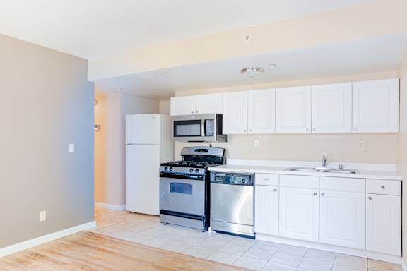 Kitchen with white cabinets and stainless steel appliances at Redwood Cove Apartments, Chico, 95928
