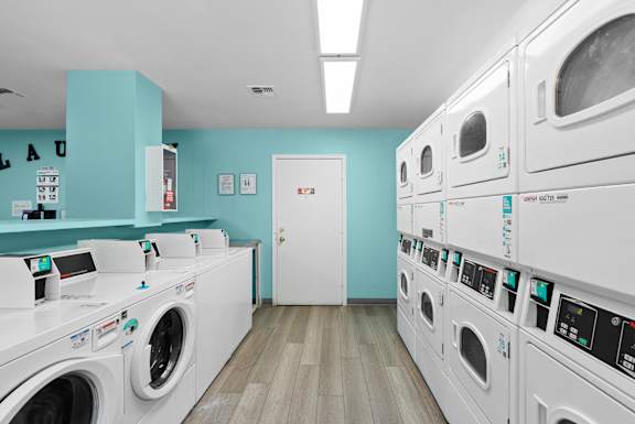 A row of washing machines in a laundromat.