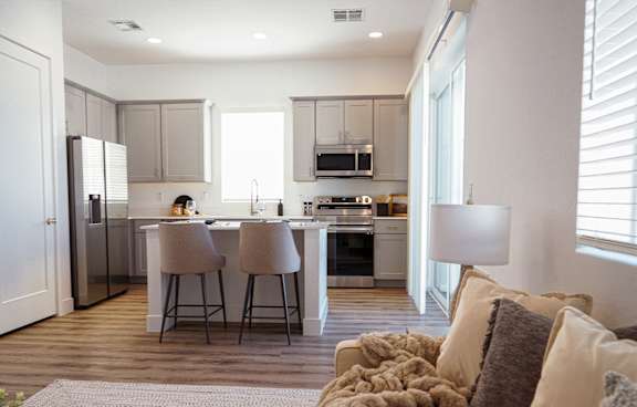 Zora Encanto modern kitchen with a dining area and a couch.