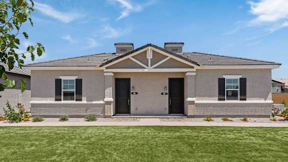 the front of an apartment with a green lawn at Zora Encanto in Phoenix