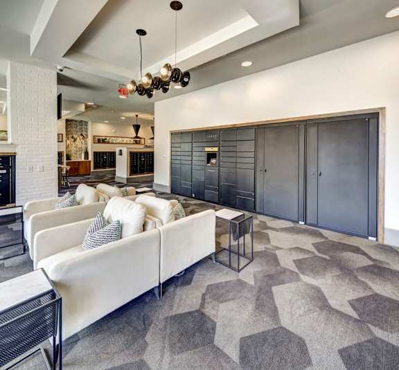 A modern living room with a white couch and a black and white rug at Arise Riverside Apartments, Austin, TX