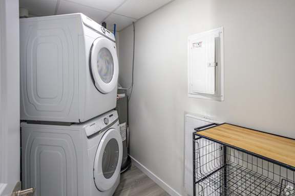 A laundry room with a washer and dryer stacked on top of each other.at Hills on 36, Edmonton
