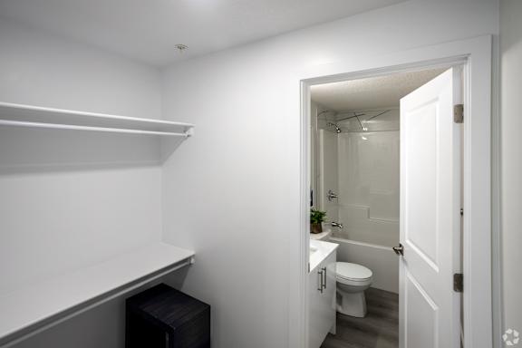 A white bathroom with a toilet and sink.at Hills on 36, Alberta, T6X 3K2