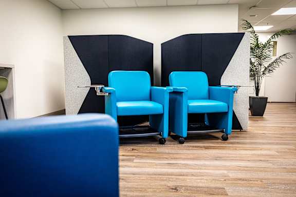 a row of blue chairs in an office