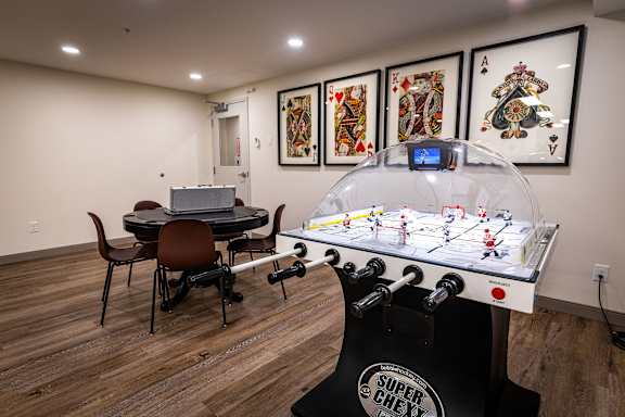 a game room with a foosball table and a ping pong table