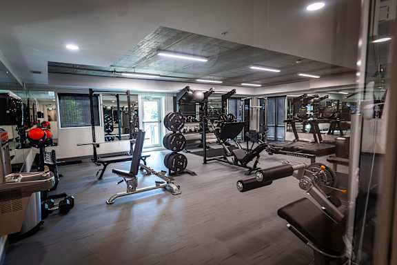 a workout room with weights and other exercise equipment